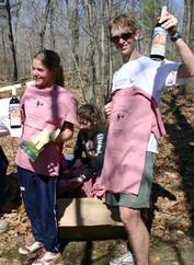 Samantha Saeger and Will Hawkins display their Billygoat t-shirts and goat trophies.