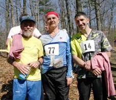 Three orienteers pose with t-shirts.